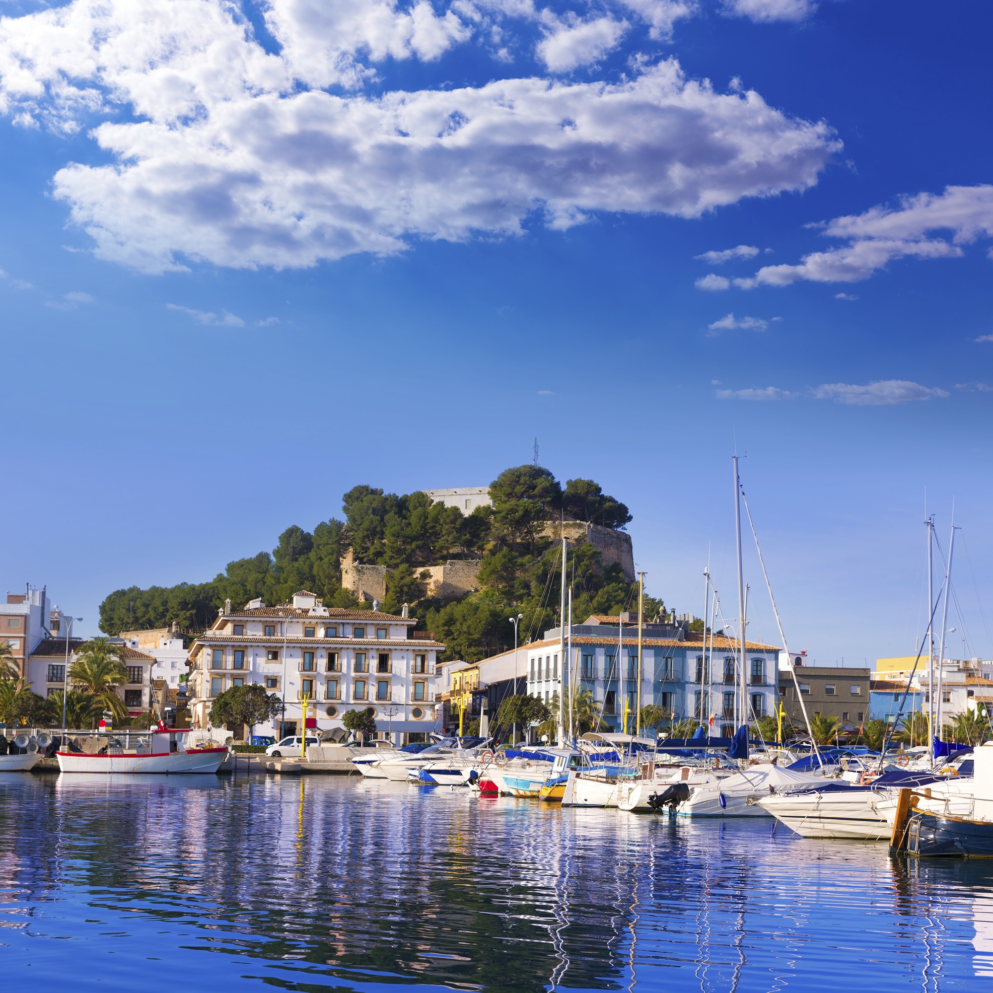 Yachts in Dénia Marina beneath the castle
