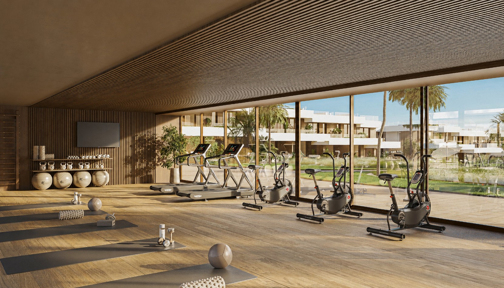 Residents’ gym overlooking the gardens, with treadmills, exercise bikes and space for floor exercises